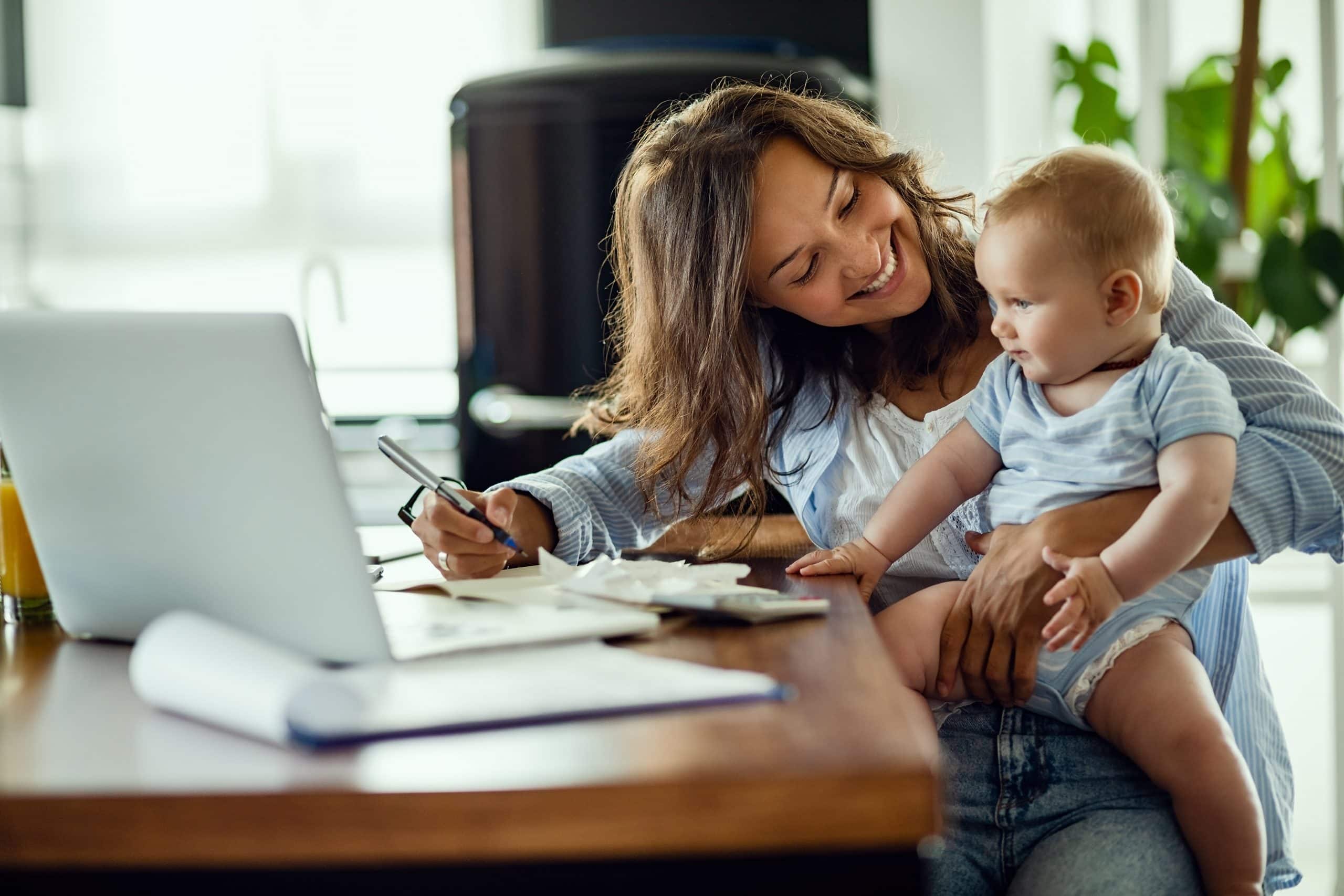 Hidden Expenses - CGT. Accompanying image: Happy mother talking to her baby while working at home.