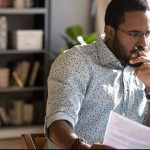 What is the court COVID-19 urgent parenting list? Accompanying picture: focused serious father holding documents looking at laptop computer screen doing online research at home office desk