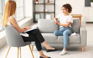Image of a young female at a consultation with a counsellor, accompanying family law article "What If I Don't Agree With The Family Report?"