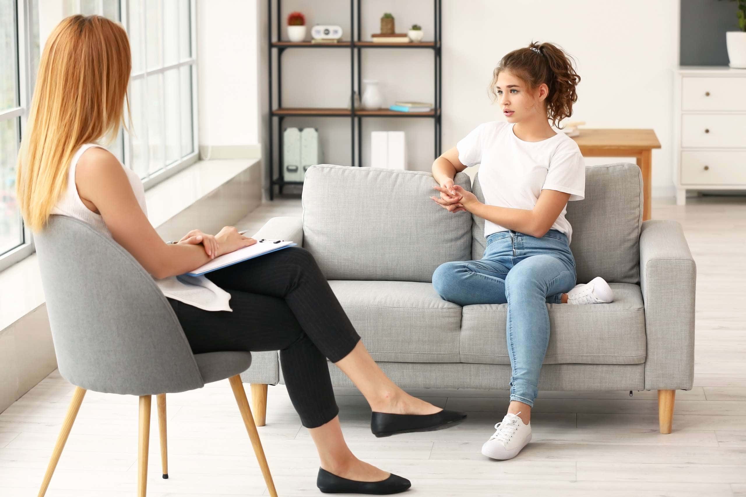 Image of a young female at a consultation with a counsellor, accompanying family law article "What If I Don't Agree With The Family Report?"