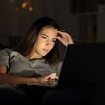 Image of a woman using a laptop in the night to accompany article "To succeed with a contravention – get the detail right" by Michael Lynch Family lawyers