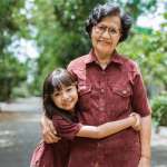 Asian grandmother with grandchildren walking together in the park enjoying a vacation