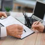 Image of papers presented for signing, accompanying family law article "Parenting Plan V Consent Order"