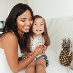 How to Get Your Child Returned? Accompanying photo: happy smiling asian woman and her daughter laughing