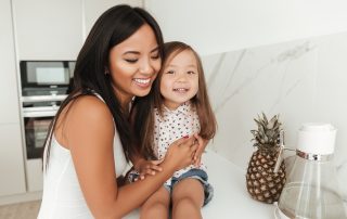 How to Get Your Child Returned? Accompanying photo: happy smiling asian woman and her daughter laughing