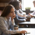 Photo of a female at the cafe, thinking