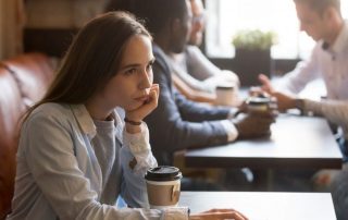 Photo of a female at the cafe, thinking