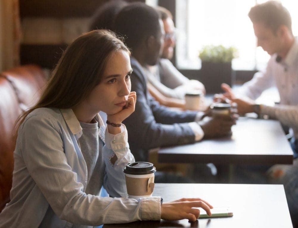 Photo of a female at the cafe, thinking