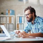 Photo of a man working on a computer