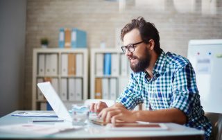 Photo of a man working on a computer