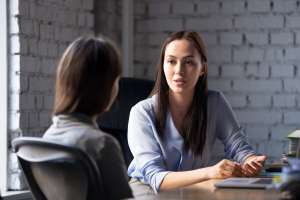 Image of two females talking to each other, accompanying family law article "Get legal advice early"