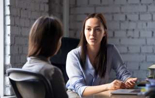 Image of two females talking to each other, accompanying family law article "Get legal advice early"