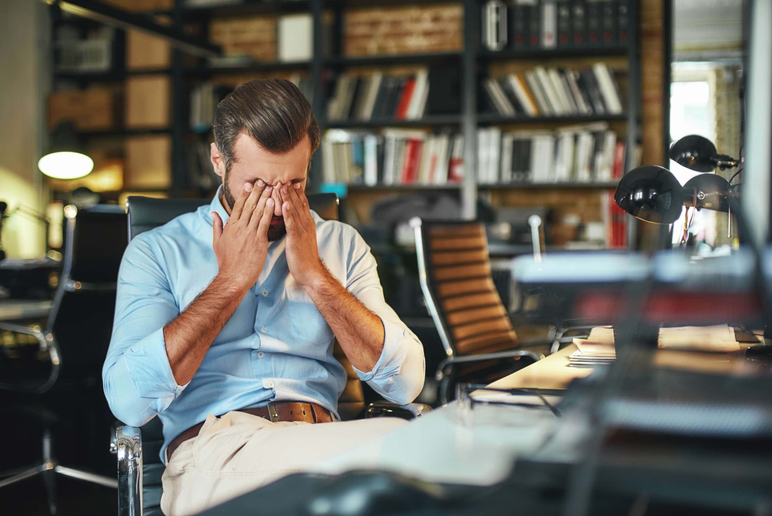 Image of an exhausted bearded businessman, accompanying family law article "How to survive separation"