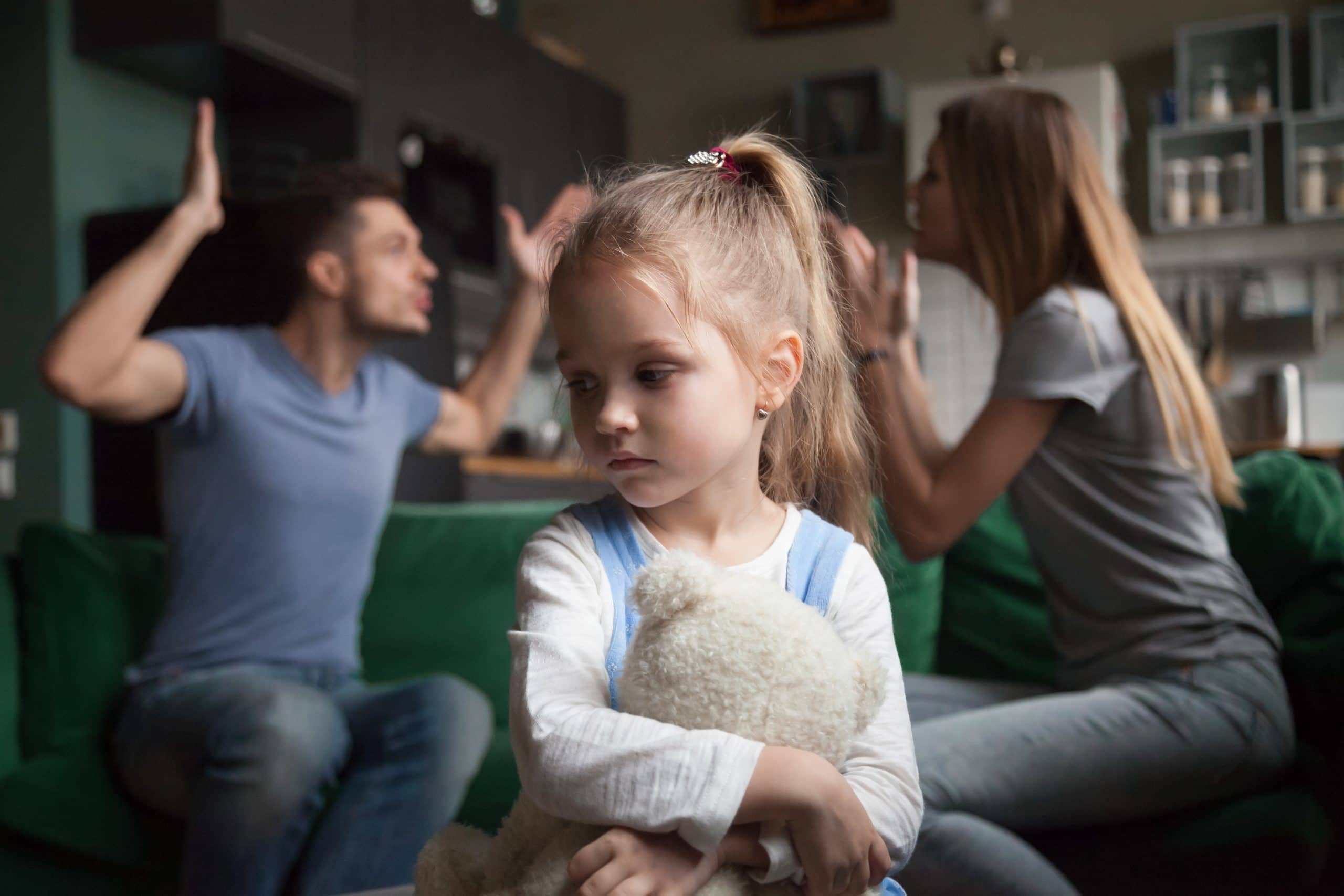 Domestic Violence Help in Queensland, Australia. Accompanying picture: A girl feels upset while parents fighting at background