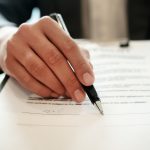 A family law accredited specialist signing documents in Brisbane.