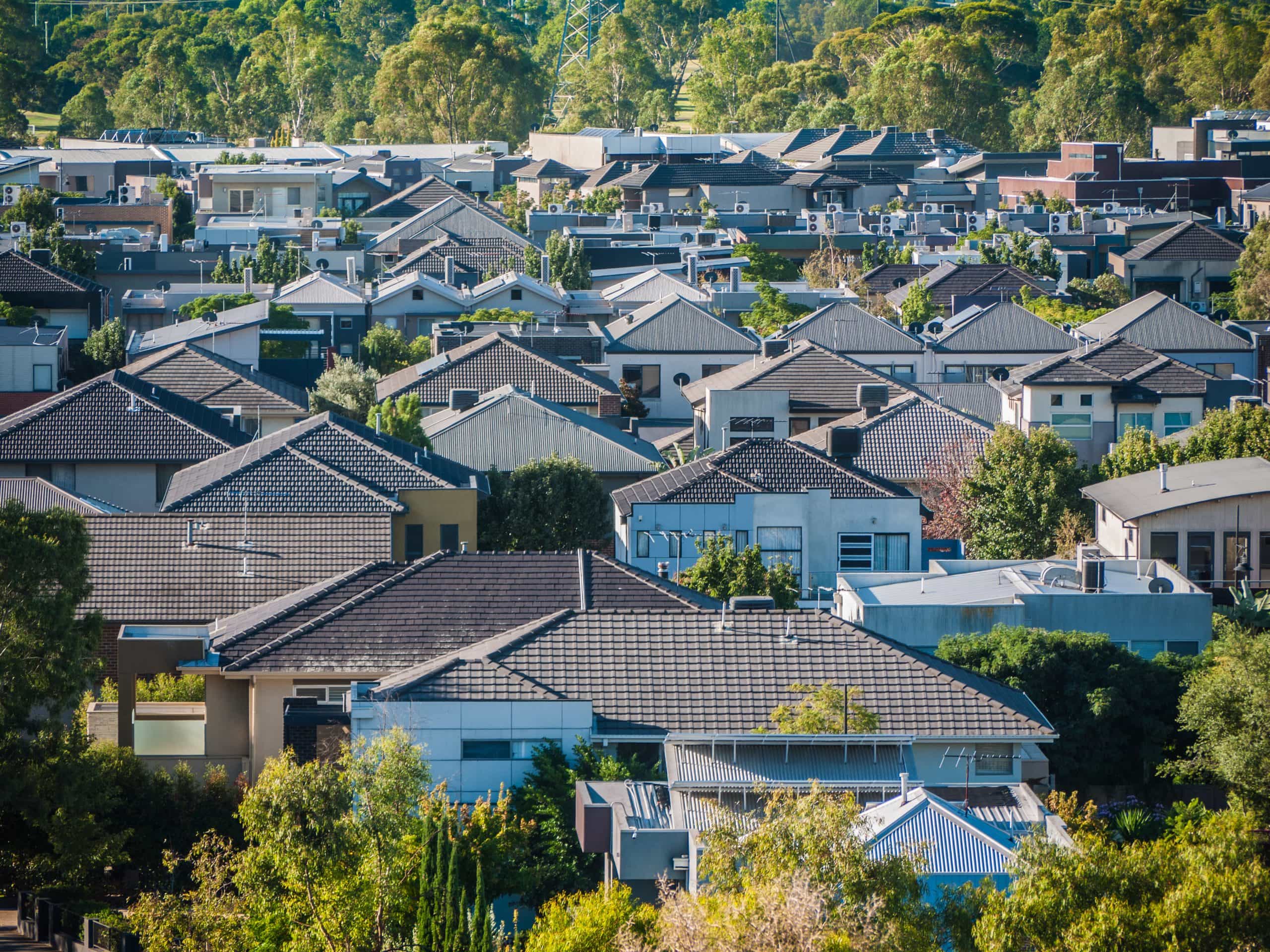 Relocation to outskirts of city after a divorce. Accompanying image: elevated view of many residential houses in suburb in Queensland, Australia.