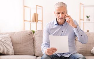 COVID-19 helpful tips if you are separated. Accompanying image: senior man talking on mobile phone holding document