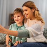 COVID-19 and Parenting Arrangements. Accompanying picture: mother and son taking selfie by smartphone at home