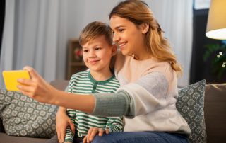 COVID-19 and Parenting Arrangements. Accompanying picture: mother and son taking selfie by smartphone at home