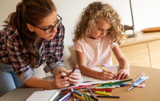 COVID-19 – Back to school and school holidays already. Accompanying image: mother and daughter drawing together at home
