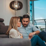 Image of a couple at home talking, accompanying the family law article "Are you in a defacto relationship?"