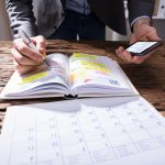 Defacto property settlement time limits. Accompanying picture: businessperson Writing Schedule In Diary