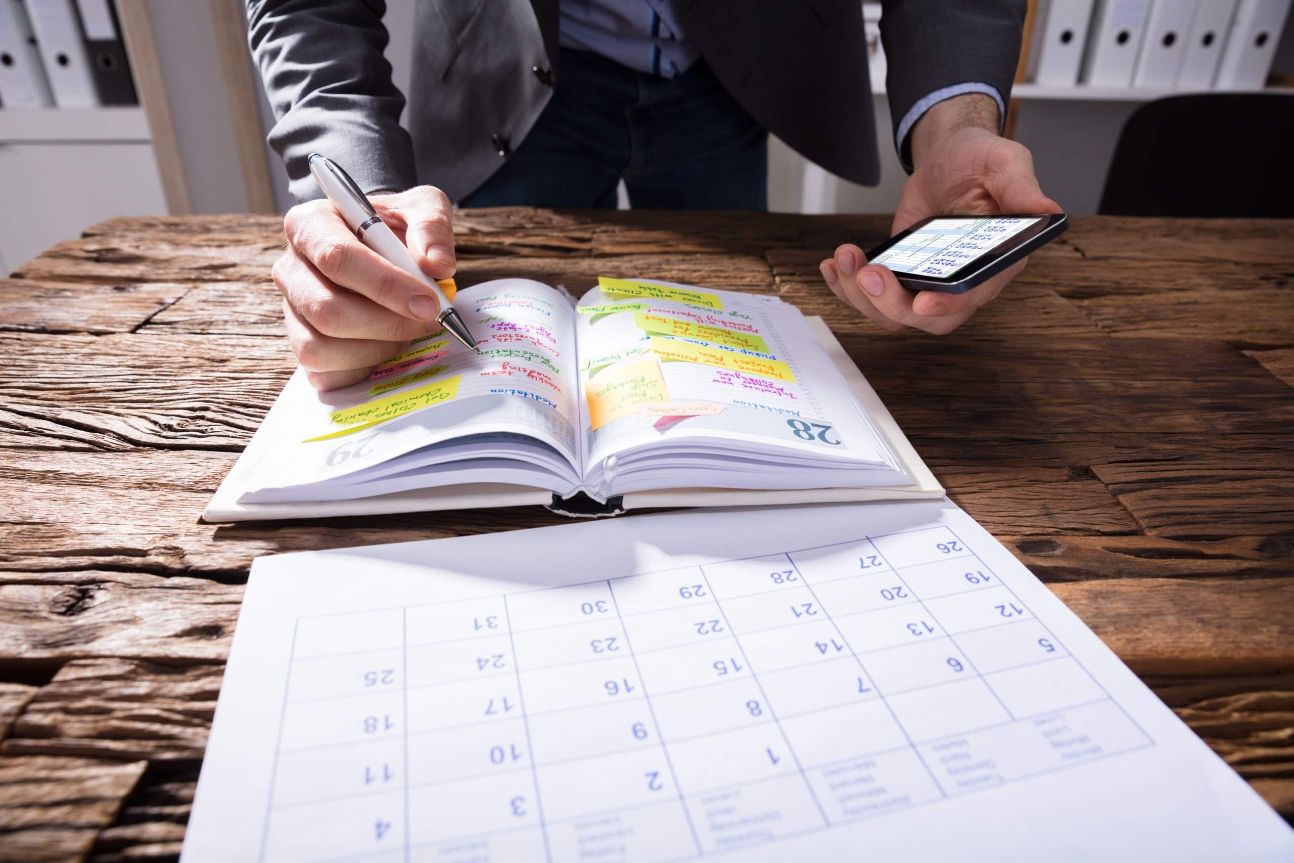 Defacto property settlement time limits. Accompanying picture: businessperson Writing Schedule In Diary