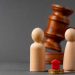 Divorce property division concept. Wooden family with house and judge gavel