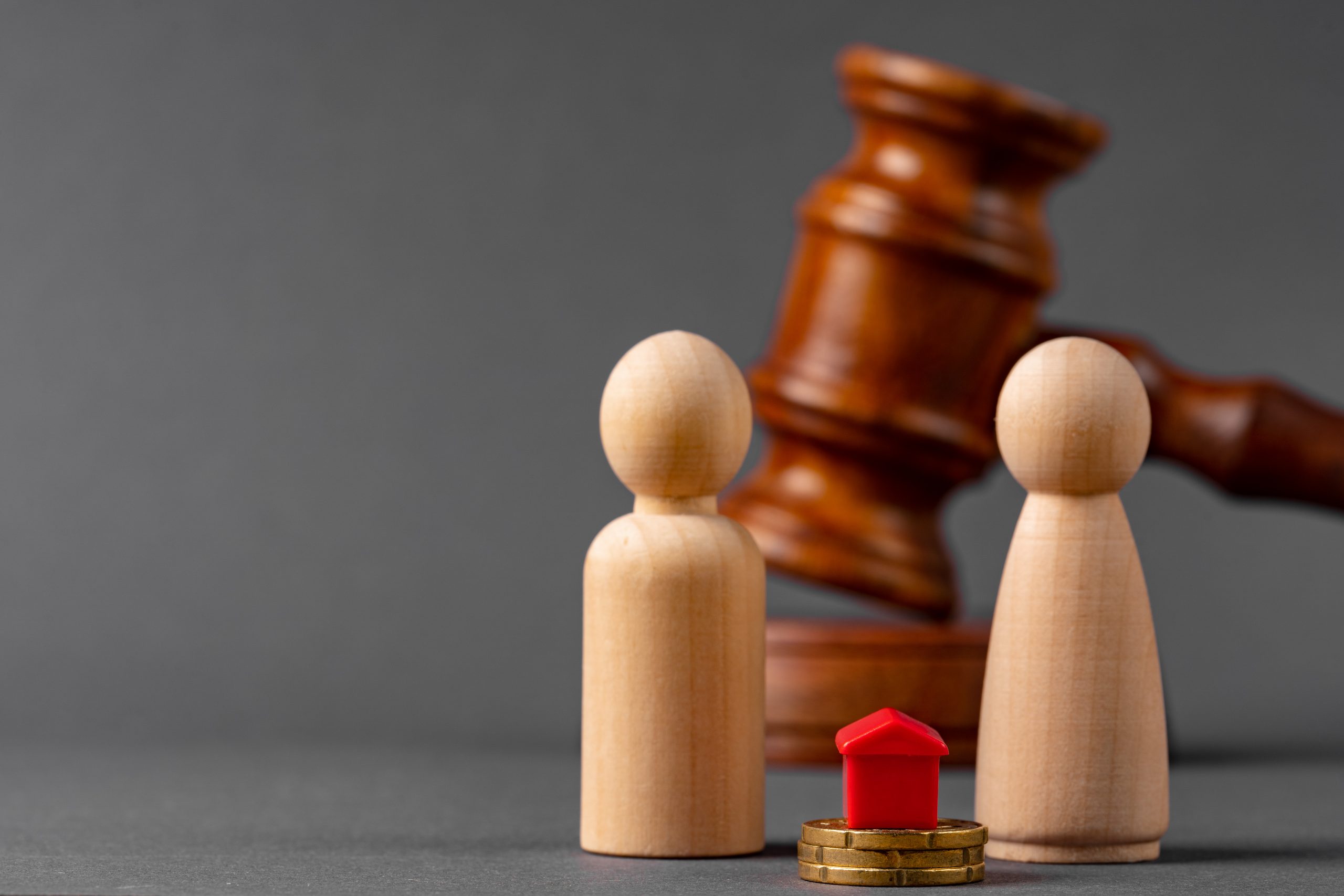 Divorce property division concept. Wooden family with house and judge gavel