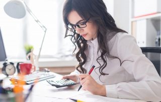 Do you need to document a divorce agreement? Accompanying picture: a young girl is sitting at the office desk, working with documents.