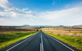 Border closures and family separation: a straight country road leading to the horizon near Killarney in Southern Queensland.