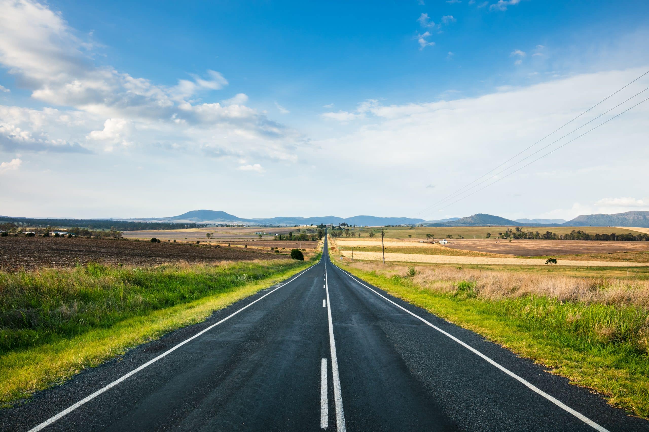 Border closures and family separation: a straight country road leading to the horizon near Killarney in Southern Queensland.