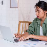 Bankruptcy and family law. Accompanying picture: a woman uses laptop in kitchen at home