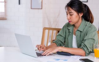 Bankruptcy and family law. Accompanying picture: a woman uses laptop in kitchen at home