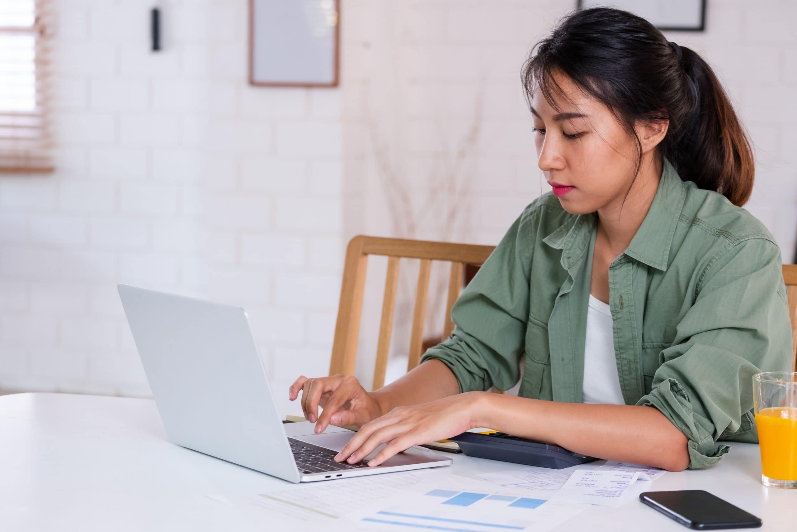 Bankruptcy and family law. Accompanying picture: a woman uses laptop in kitchen at home