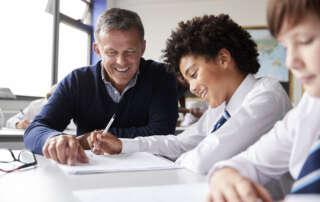 Image of students and a teacher, accompanying the family law article "Child support and school fees - who pays?"