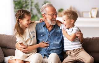 Image of a grandfather with his grandchildren, accompanying family law article "Grandparent rights - a grey area"