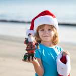 Image of a boy wearing a Santa hat, accompanying family law article "The 10 Do’s and Don’ts of Family Law for Christmas"