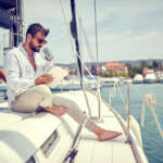 Image of relaxed businessman working on the yacht accompanying family law article "Protecting your assets in a divorce"