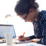 Image of a young woman working in her office.