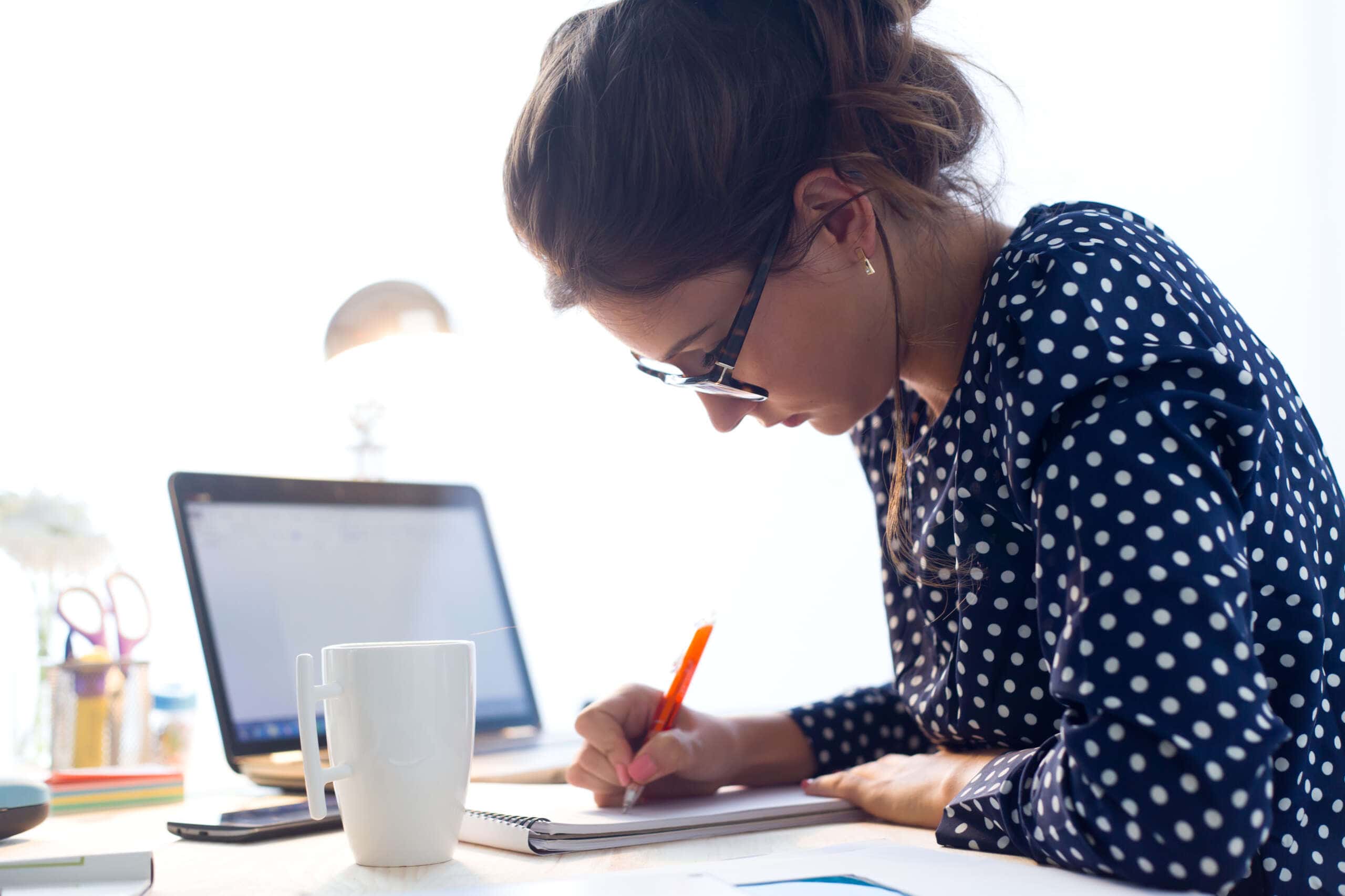 Image of a young woman working in her office.