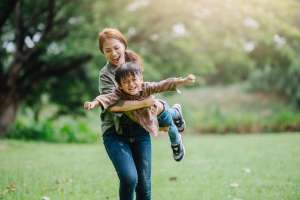 Image of a mother playing with her son, accompanying family law article "How Do I Make A Parenting Plan"