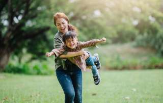 Image of a mother playing with her son, accompanying family law article "How Do I Make A Parenting Plan"