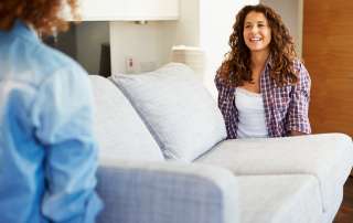 Image of two women, accompanying family law article "Who gets the couch? How the Court deals with the furniture"
