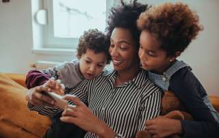 Image of a happy mother with children, accompanying family law article "Keeping the Lines of Communication Open"