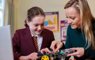 Image of a student and her teacher accompanying family law article "Teachers are head of the class for helping kids"