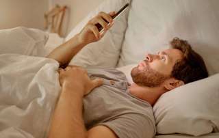 Image of a man on his phone, accompanying family law article "Quick tips – a guide to parenting after separation"